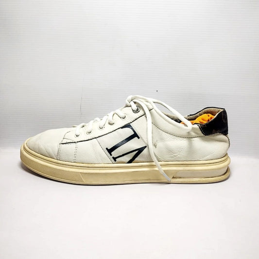 white leather sneakers with the letters "VL" on the side